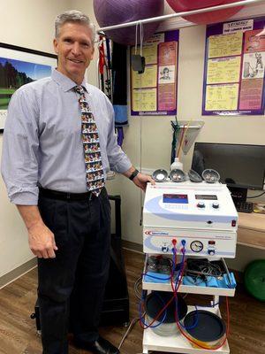 Dr. Clare in front of the Matrix Pain Management Machine