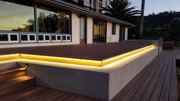 LED light tube under edge of Fiberon composite, above concrete ledge.