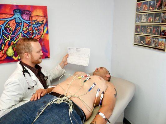 Dr. O'Boyle explaining an EKG (electrocardiogram) used for preoperative reports, chest pain, dizziness, and abnormal heart rhythms