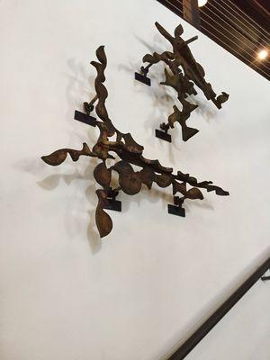 Italian wall sculptures made from patinated steel cut-outs.