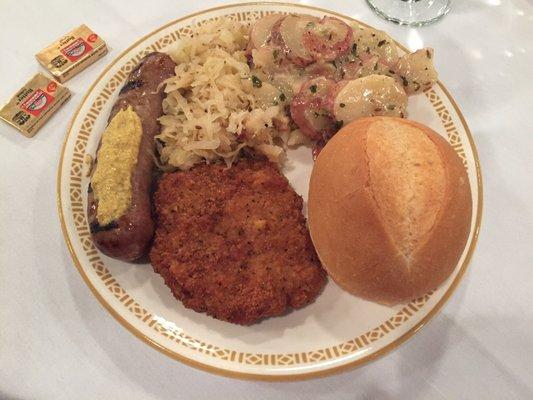 Schnitzel, sausage, German potatoes and sauerkraut