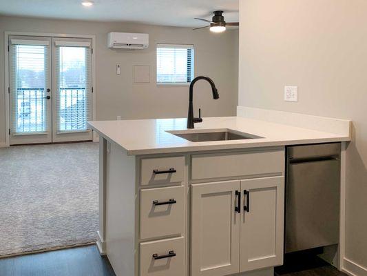 The Finch studio apartment with white cabinets.