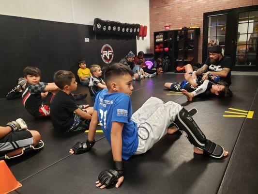 Youth MMA class in Murrieta. Kids watching the drill.