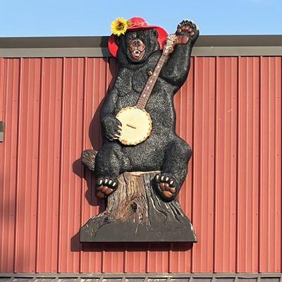 Lilly Bear hangs outside our Opry and welcomes out guests. This was carved and painted by one of our talented local artists.