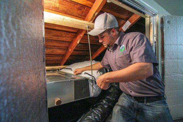 GreenSavers HVAC technician installing heat pump (also called mini split)