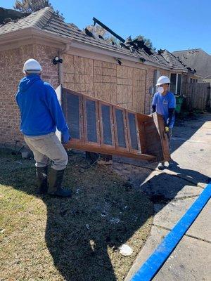 Emergency response teams helping salvage some sentimental items after a house fire.