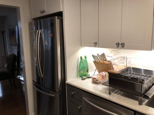 New counter depth French door refrigerator and paneling for a built-in look.