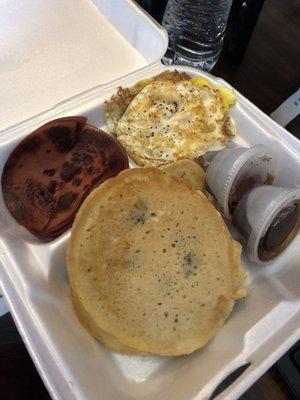 Blueberry pancake platter with bologna and eggs