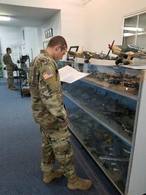 A member of the Missouri National Guard looks at the model airplanes.