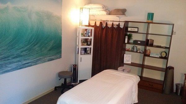 Professional, clean Massage treatment room with a comfortable heated table available