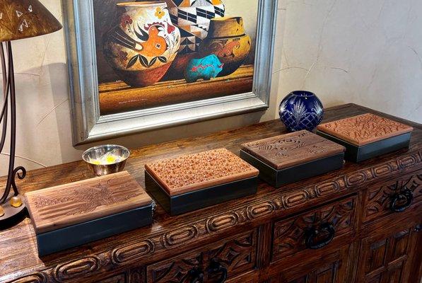 BoscoBox Safety Boxes a display of four on a dresser in different wood finishes