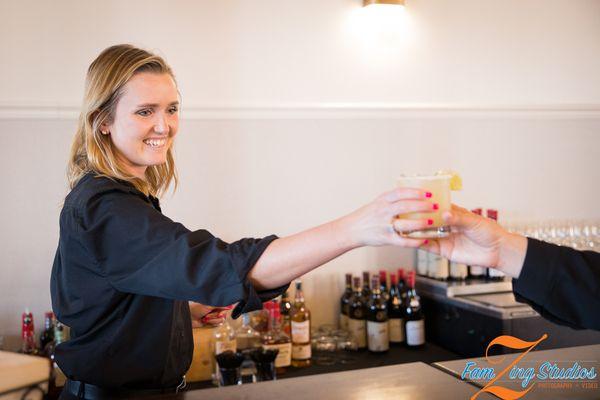 A Liquid Catering bartender serving up smiles!