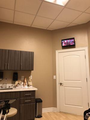 Clean exam room with a flatscreen