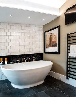 Soaking tub with towel warmer