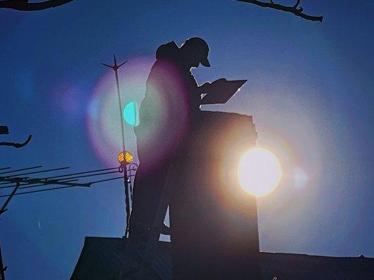 An aesthetic silhouette shot of Sid (owner) during an annual cleaning of a regular customer