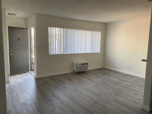 Open, well lit living room with A/C.