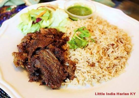 Pulled beef  marinated in spices. Indian Rice and salad