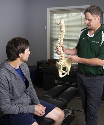 Dr. Norman educating a patient about spinal function