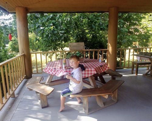 Picnic table on front porch. Great place for a meal or to play games.