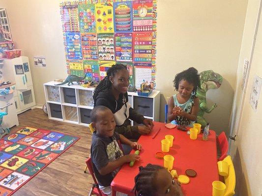 Ms Shyann with the children's having play dough fun