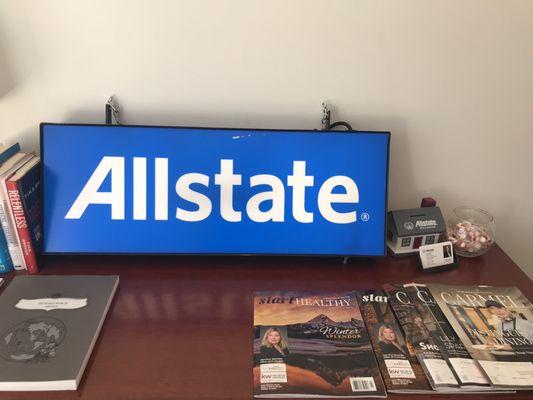 Allstate sign on the table with local journals