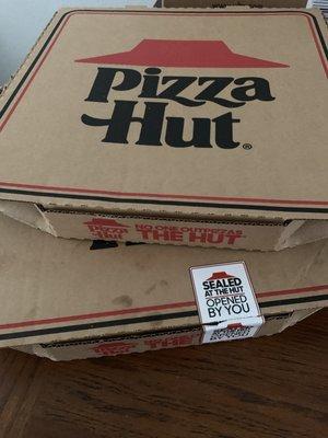 The top pizza box was the pizza they delivered without the proper seal.