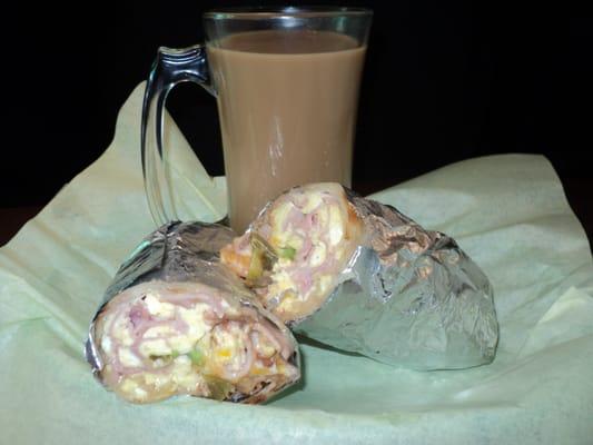 Lovely Breakfast Burrito with egg, cheese, beans, sour cream, ham, house recipe secret salsa and other yummy ingrediants