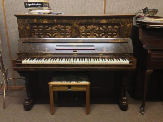 This is a beautiful antique piano that the owner, Yury, has restored by hand.