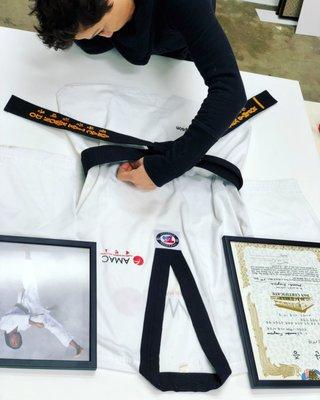 Matin working on a very special piece for our client. Framing a Karate Uniform.