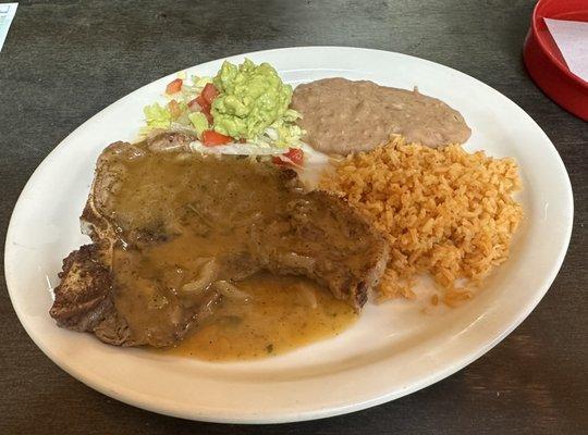 Delicious steak ranchero with rice, beans, salad and guacamole