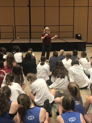 Kristen Hale speaking to a group of high school athletes.