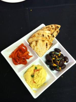 Mediterranean Sampler: Hummus, Olives, Roasted Peppers, and Pita.