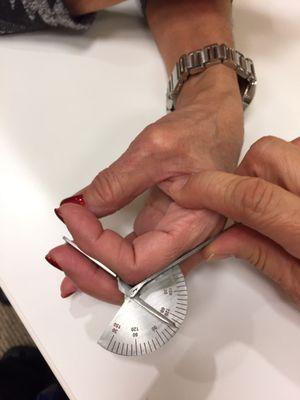 Measuring finger motion with a goniometer.