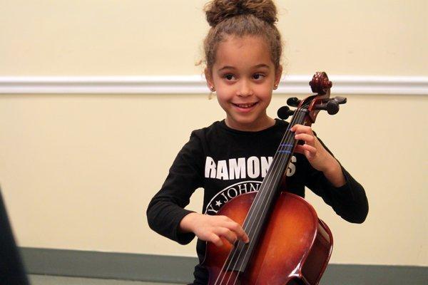 Suzuki cello student in private lesson.