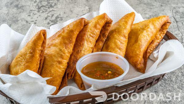 Fried pastry filled with chicken or beef, onions and cilantro