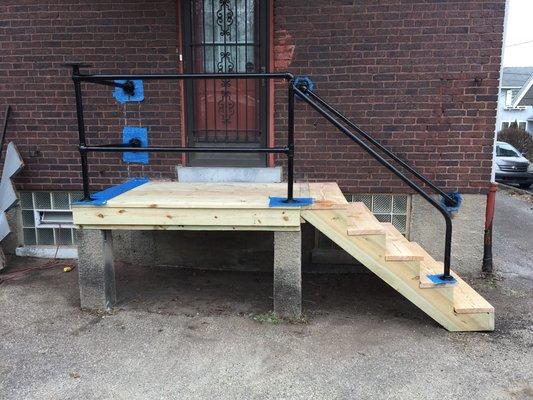 Replaced damaged wood on back porch. Stained wood & sealed