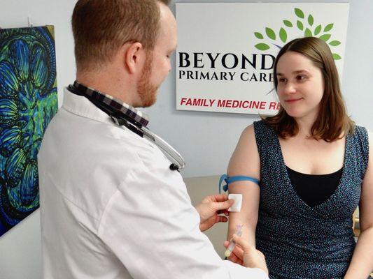 Dr. Jeff OBoyle doing a blood draw on a patient at the office.