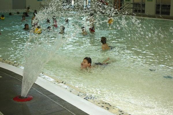 Heated lap swim pool and a zero-entry pool with a river channel