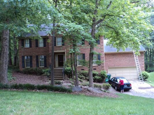 Trees help keep moisture on roof.
 That shortens the shingles life expectancy