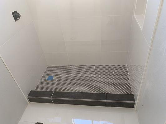 Shower tile installer replaced fiberglass shower stall with new tile installation.