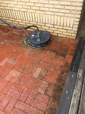 Getting the moss, mildew and gunk off of the poolside brick patio.