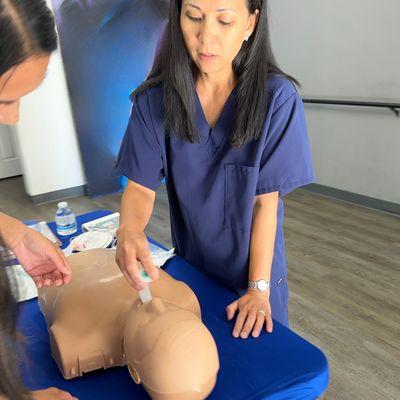 ACLS Instructor, Michelle, validating nurses in the airway skills station.