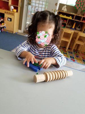 Tiny fingers building fine motor skills.