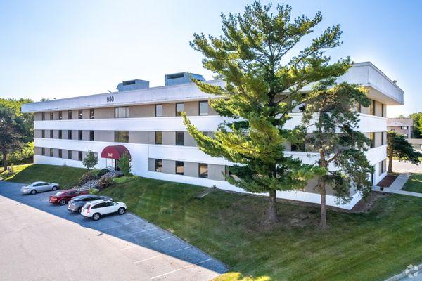 Exterior of building. Ramp located on back side of the building with additional parking.