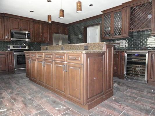 All maple. Raised panel doors. Leaded glass in bar doors