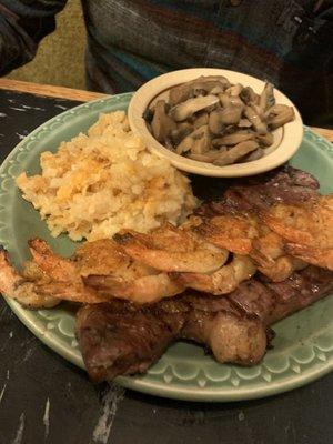 My husband's special of the New York strip and shrimp with their seasoning on top and sides of hash brown casserole and mushrooms.