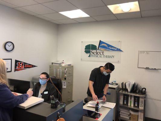 Front Counter. Therapist Billie in a black shirt