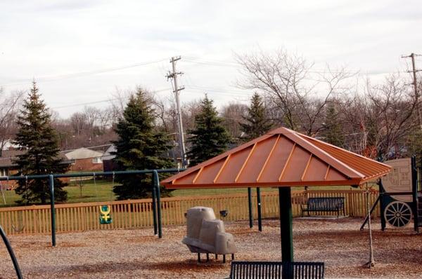 The covered benches in the middle of the playground make it shady in the middle of a hot summer's day