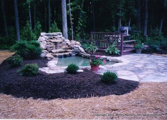 Water fall, pool, landscaping, and natural stone patio in a residential back yard in Pataskala.