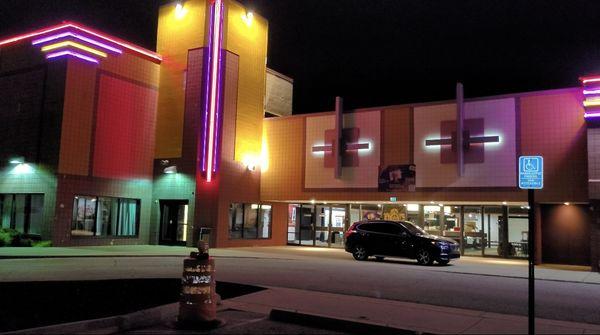 Greenwood District Studios, home of Funny Is Funny Comedy Club, at night.